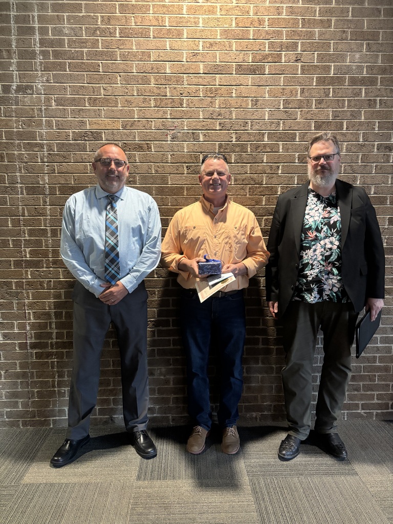 Three people standing by lobby wall