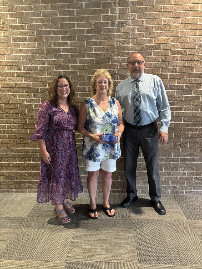 Three people standing by lobby wall