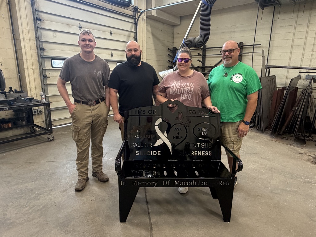 Sam Weeks, Mason Fisher, Brandie Reid and Rick Reid with a bench that Welding students made