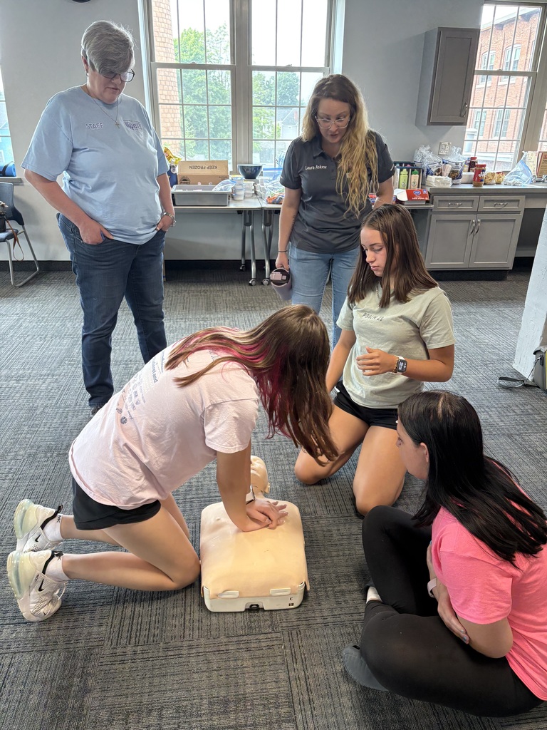Students practicing CPR as others look on