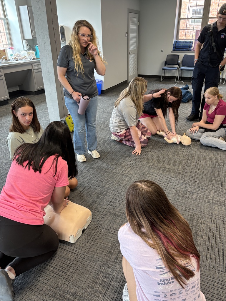 Students practicing CPR as others look on
