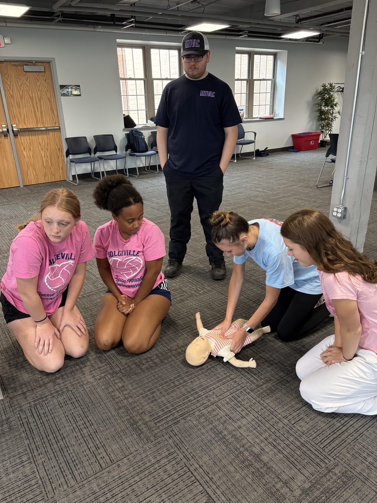 Students practicing CPR as others look on