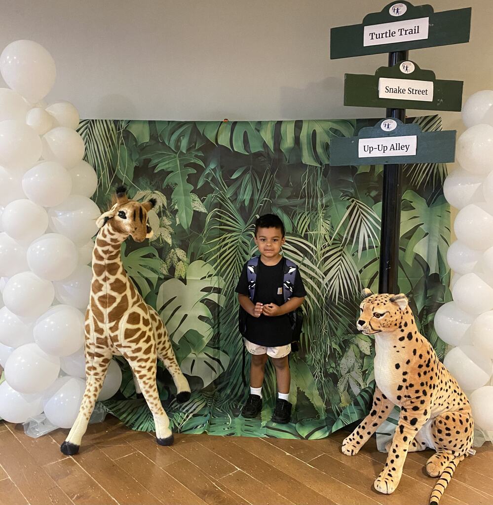 Student posing by zoo display