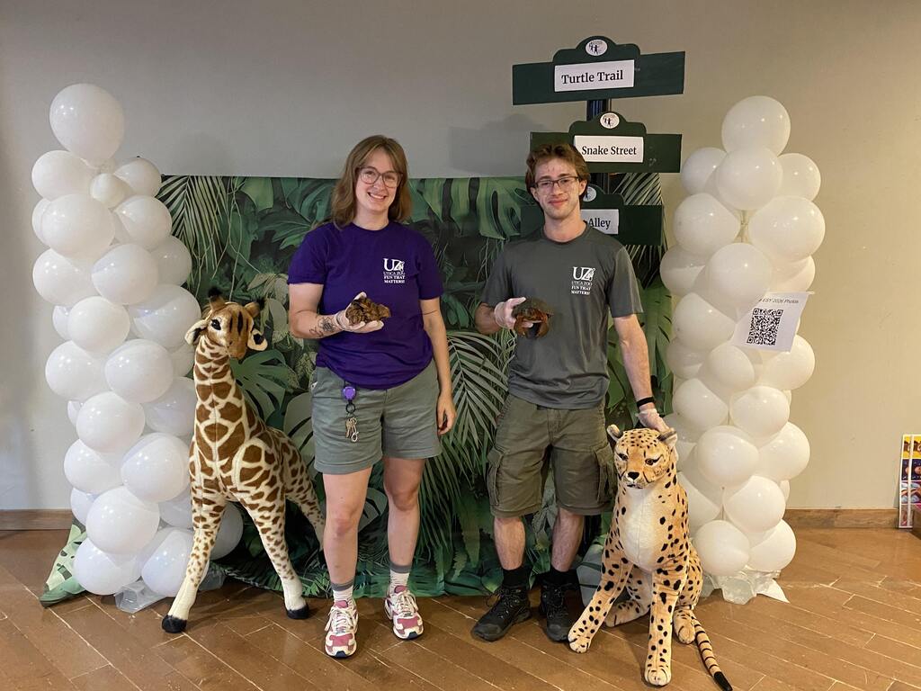 Two people by zoo display