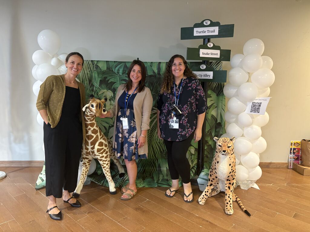 three people by zoo display