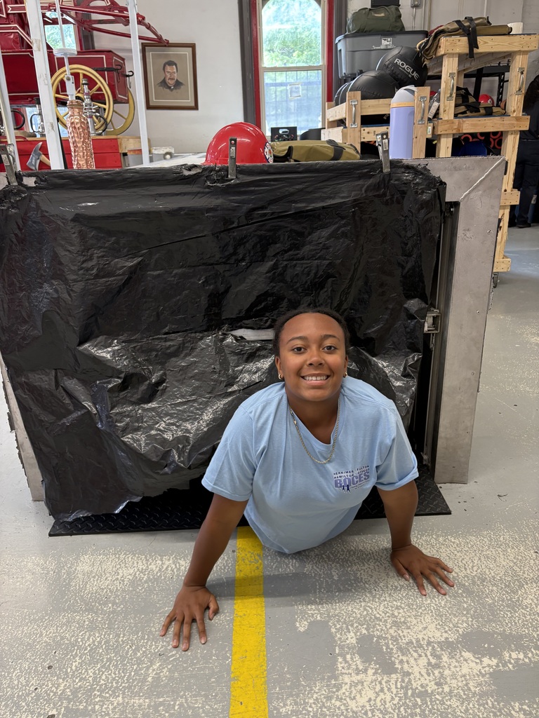 Student crawling through obstacle