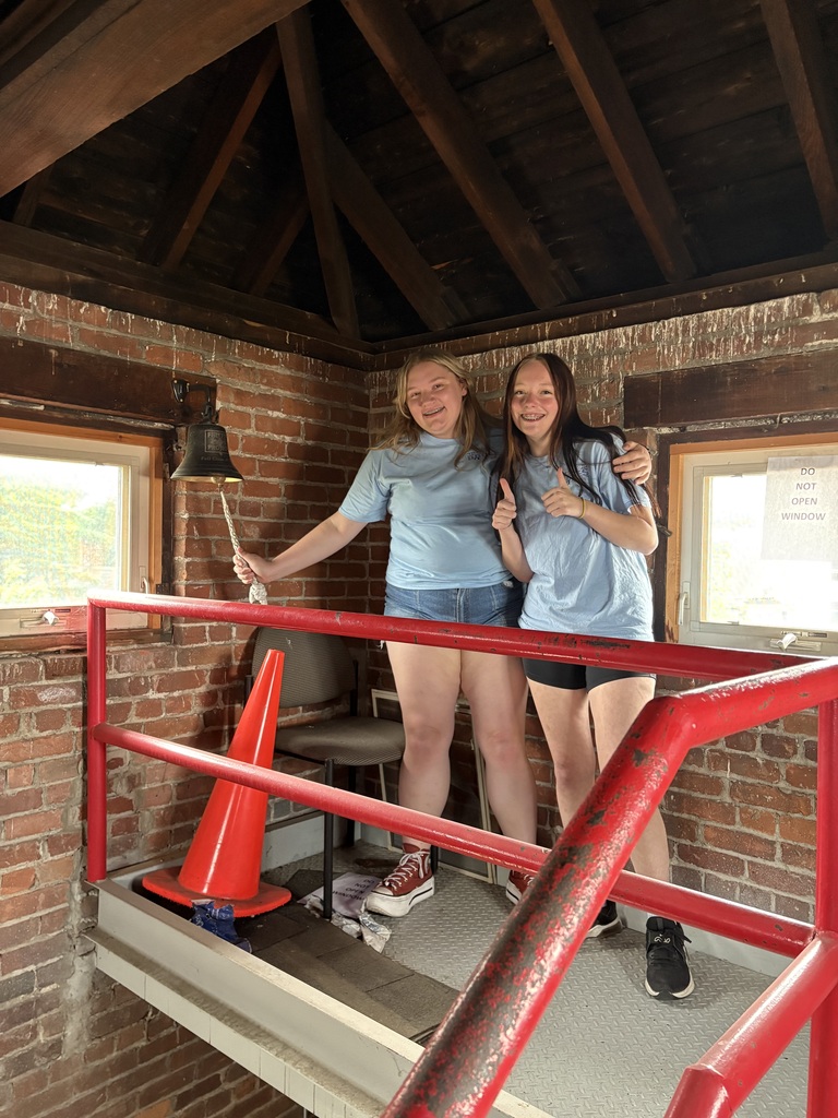 Two students ringing a bell