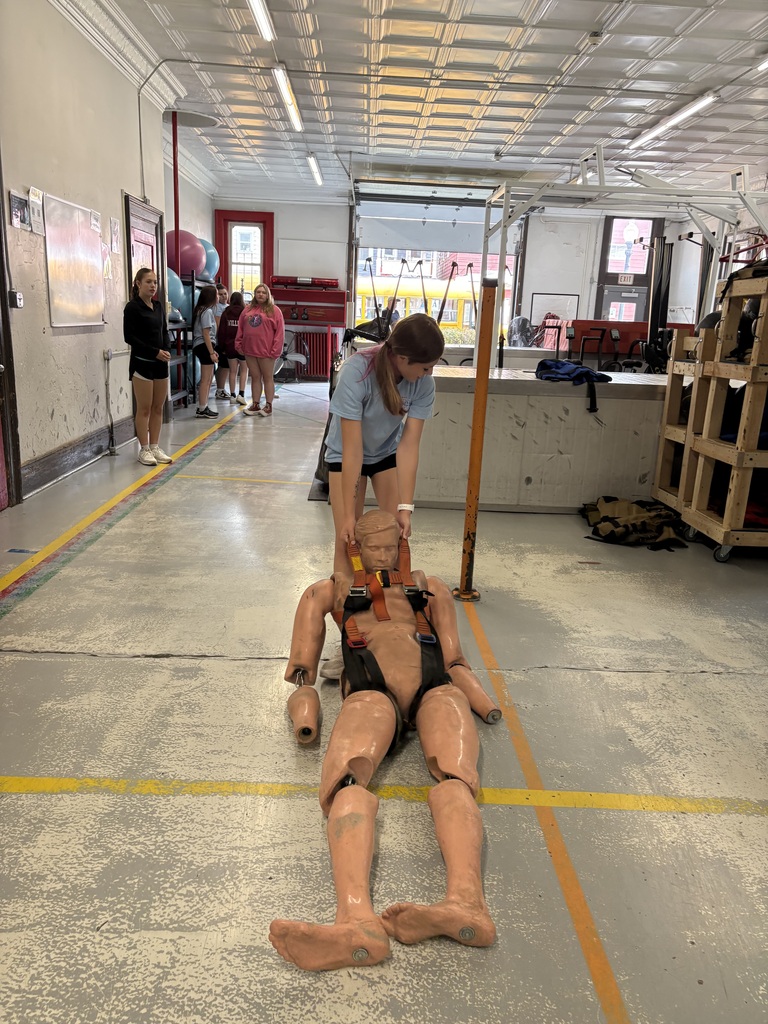 Student dragging a dummy