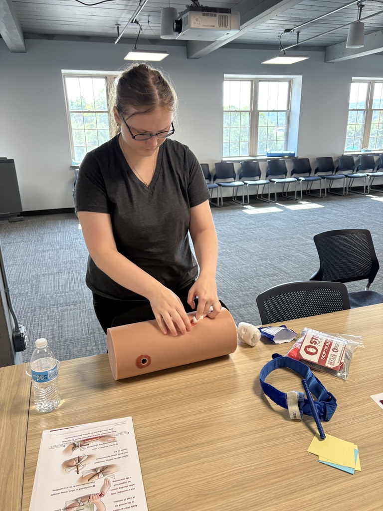 A student practicing Stop the Bleed training