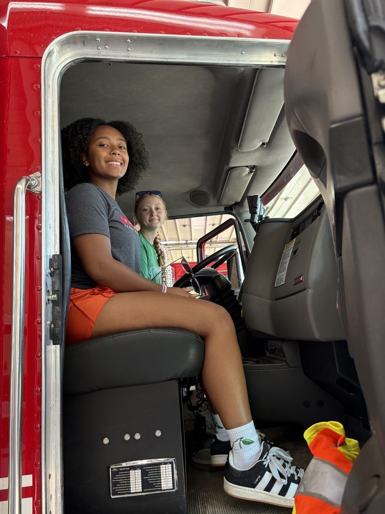 Two students in front seat of ambulance