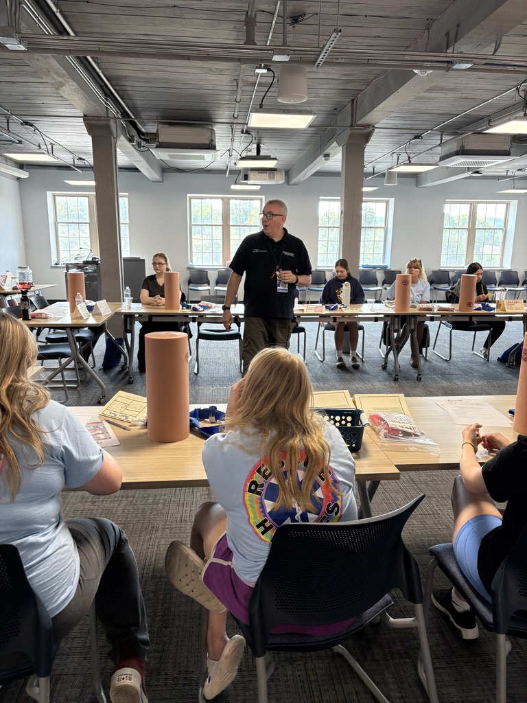 Presenting speaking to students sitting at tables