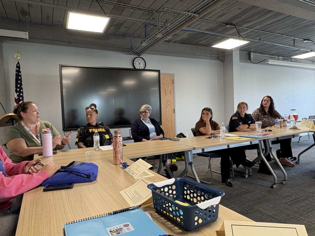 emergency services professionals sitting at tables for a panel discussion