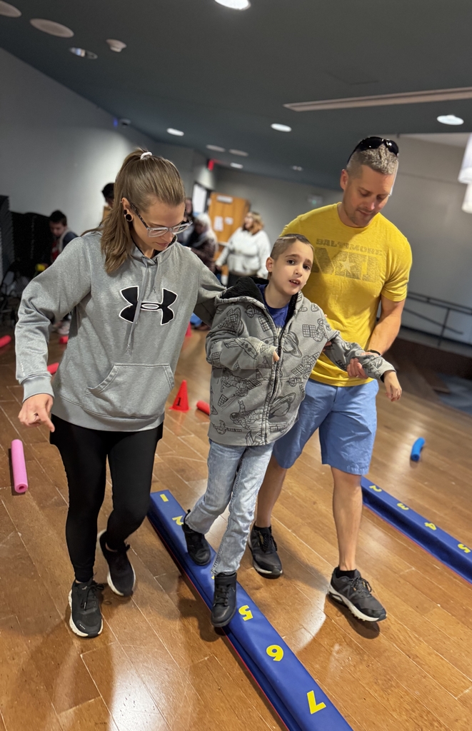 Student walking on board with two adults