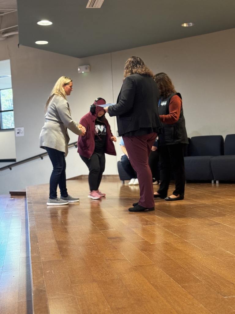 Student Council member shaking hands on stage as being recognized