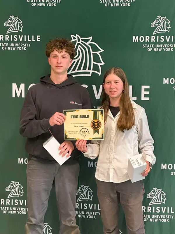 Two students posing with certificate at state conservation competition