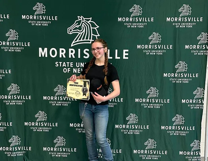 Student posing with certificate at state conservation competition