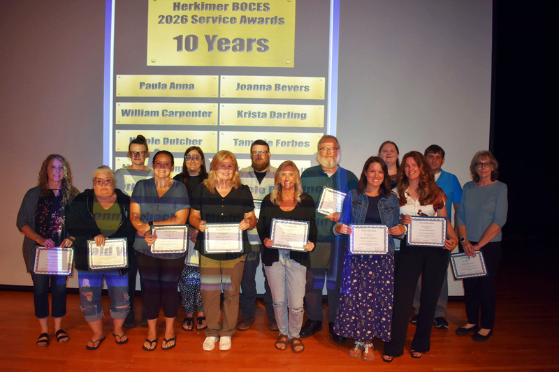 14 staff on stage with 10 year awards