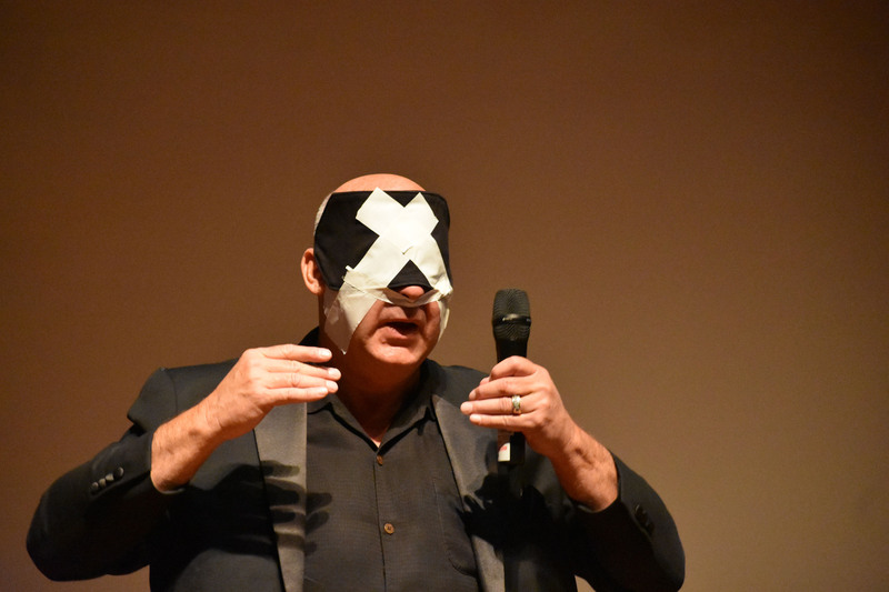 Mentalist Robert Channing performing with a blindfold and tape on his face