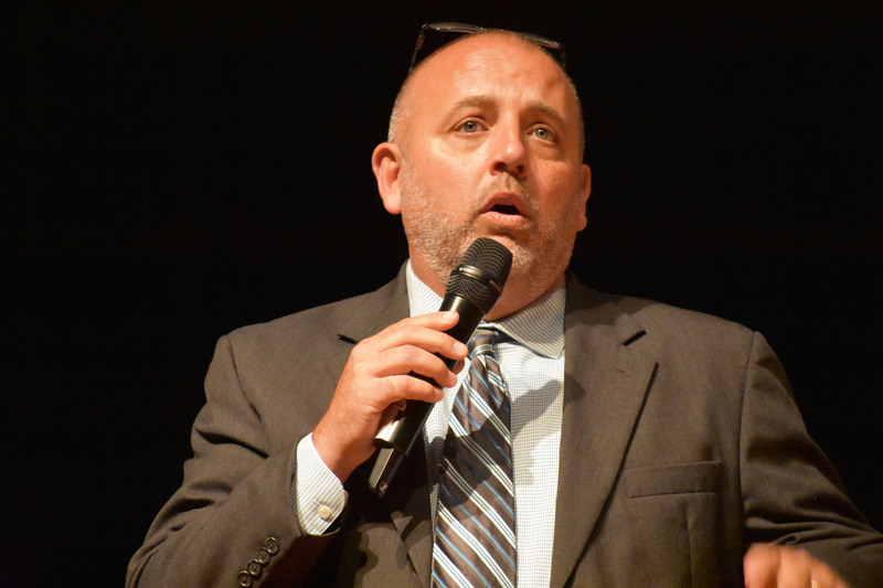 D.J. Shepardson speaking into microphone