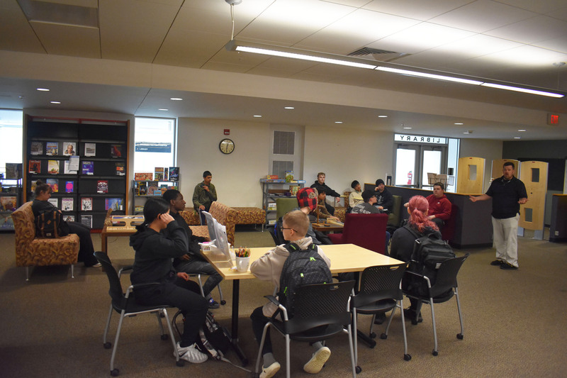 VP-TECH students in various seats listening to Herkimer College library director in library