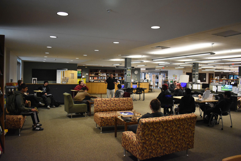 VP-TECH students in various seats listening to Herkimer College library director in library