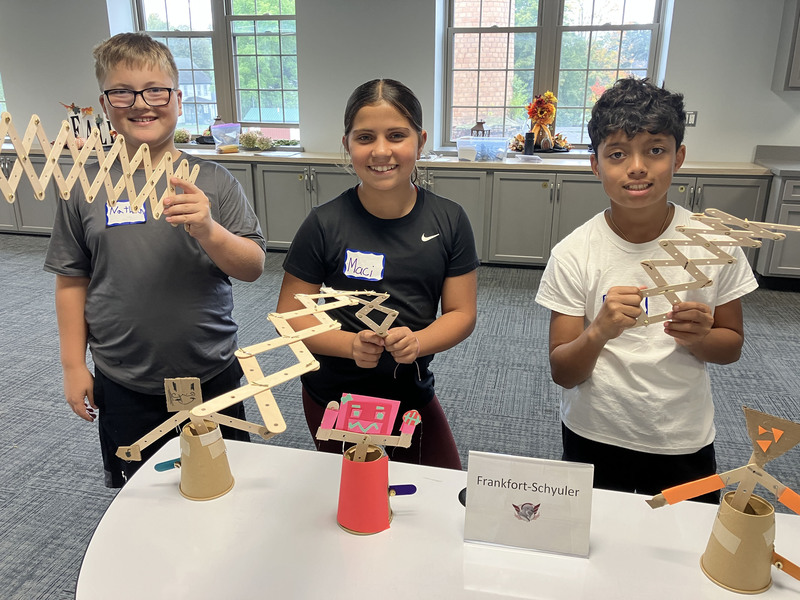 Students posing with engineering projects