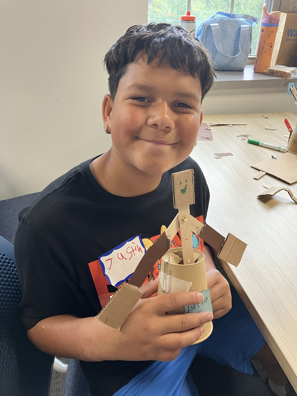 Student posing with engineering projects