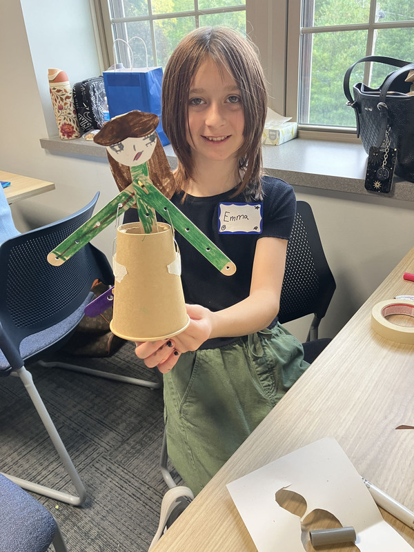 Student posing with engineering projects