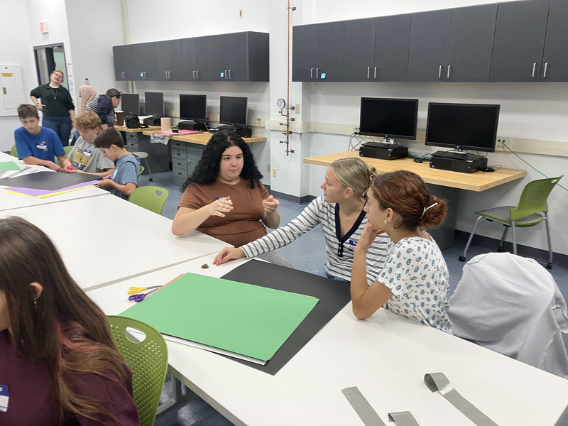 Students at tables in a classroom during SUNY Poly Tour