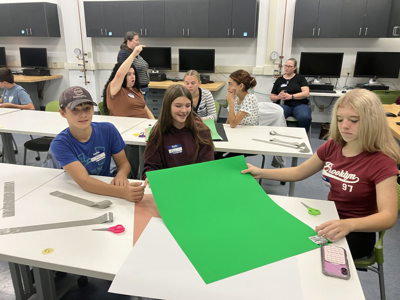 Students at tables in a classroom during SUNY Poly Tour