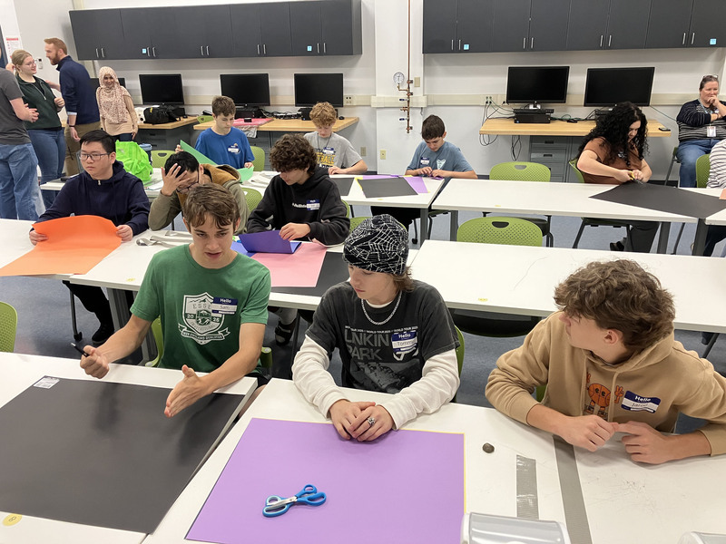 Students at tables in a classroom during SUNY Poly Tour