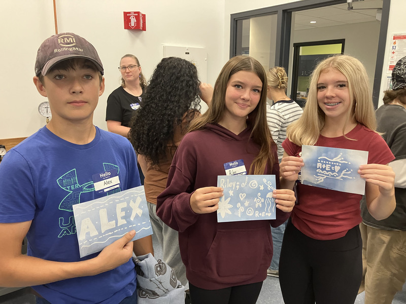 Students posing with art they made