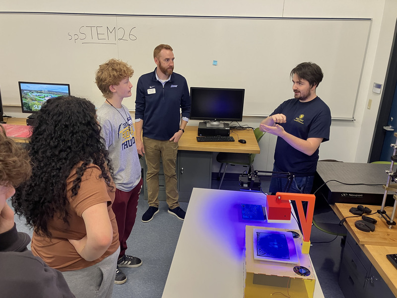 Students and tour guides talking in classroom