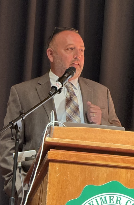 DJ Shepardson speaking on stage