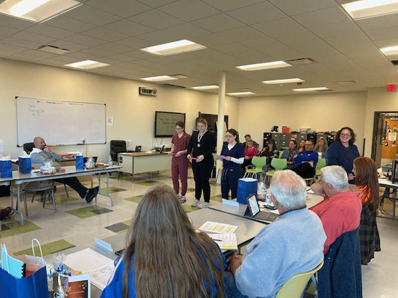 Three Health Science Careers students presenting at Herkimer BOCES Board of Education meeting