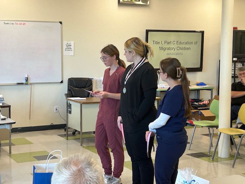 Three Health Science Careers students presenting at Herkimer BOCES Board of Education meeting