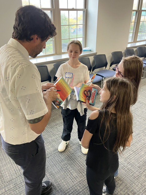Graphic novelist Ira Marcks talking with three students