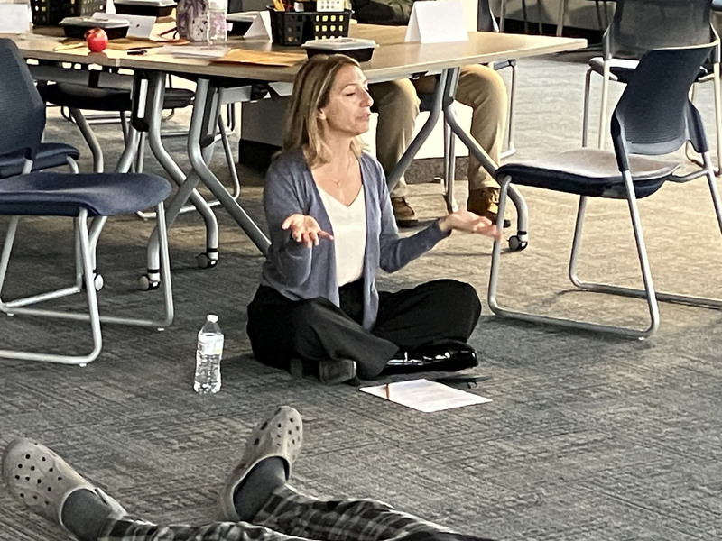 Mindfulness consultant leading yoga