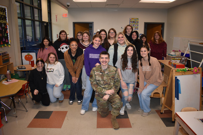 Brother and sister posing with Child and Family Services students