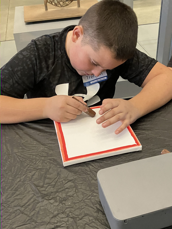 Students doing artwork at art museum