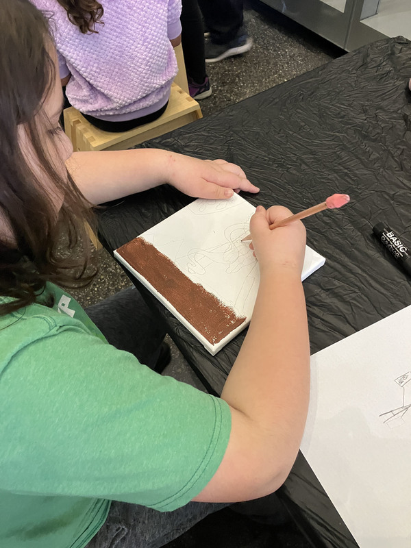 Students doing artwork at art museum