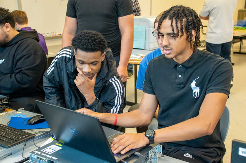 Two students working on computer