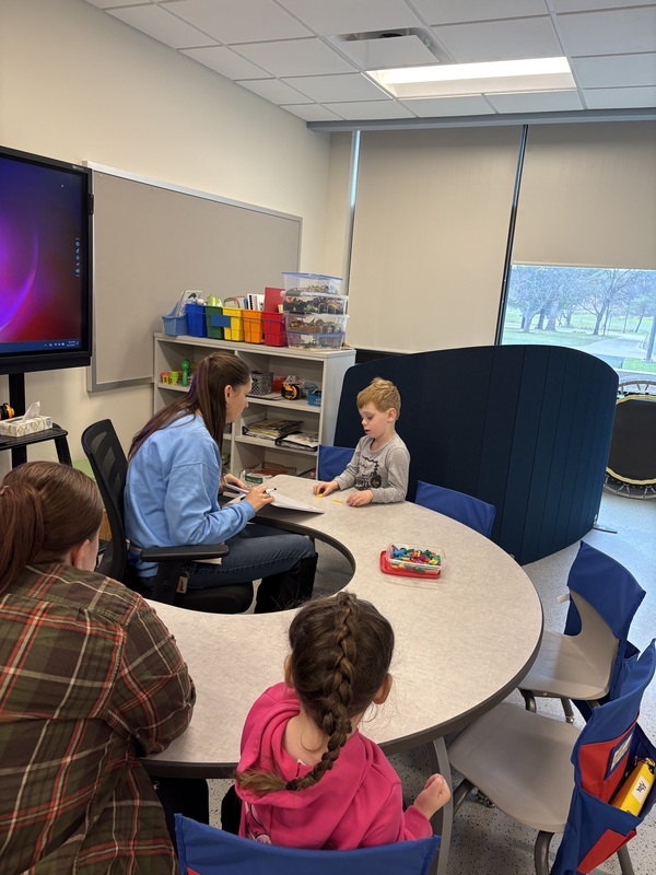Leanne Byard in classroom working with a student