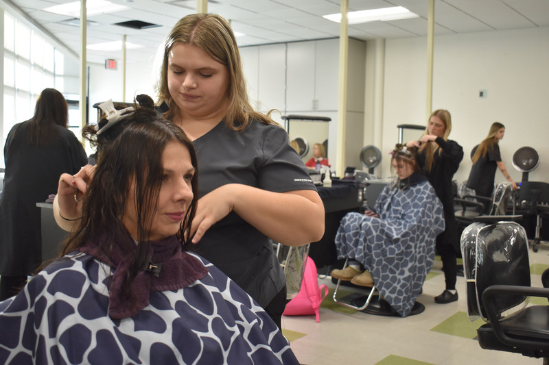 Student cutting mother's hair