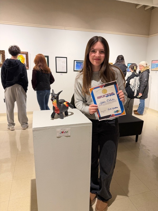 Herkimer student posing in art gallery