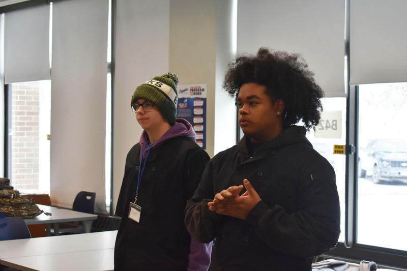 Two students presenting in culinary classrom
