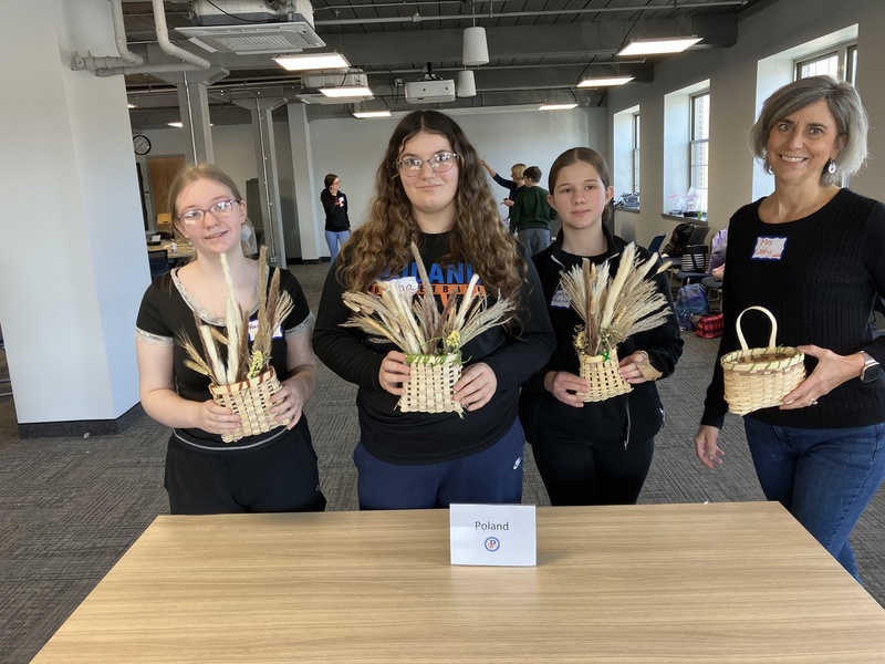 Students and staff member posing with baskets