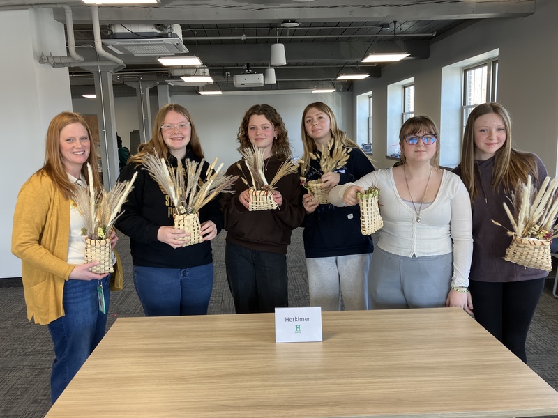 Students and staff member posing with baskets