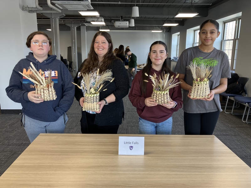 Students and staff member posing with baskets