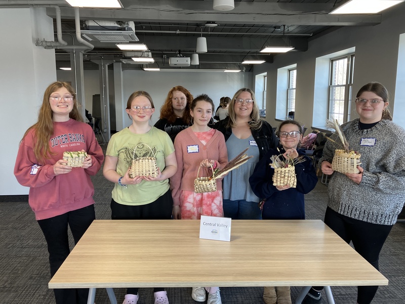 Students posing with baskets